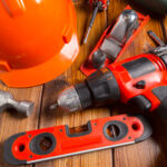 Assorted work tools on wood background